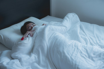 Woman with scare and panic while lying down under the blanket in bedroom,Nightmare or bad dream