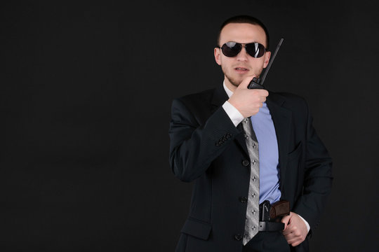 Caucasian white male bodyguard or secret service agent on a dark background. policeman in civilian clothes