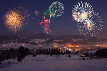fireworks at mountain landscape. view of holiday city