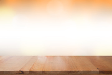 Empty desk with blurred light orange gradient bokeh abstract background