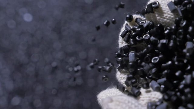 Plastic black gray granulated crumb. Manufacture of plastic water pipes of the factory. Process of making plastic tubes on the machine tool with the use of water and air pressure.