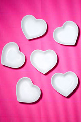 A pink background and a white plate.