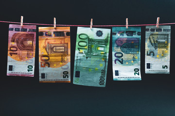 euro bills on a rope with clothespins