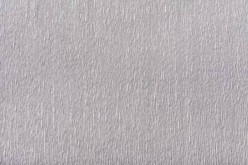 Textural of silver background of wavy corrugated paper, closeup.