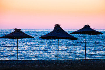 Beach umbrellas made of palm leaves
