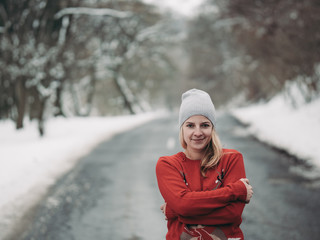 Portrait of cute blonde woman outdoor. Winter forest.