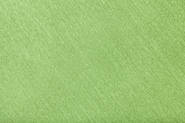 Fototapeta na wymiar Textural of green background of wavy corrugated paper, closeup.