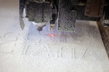 milling machine cuts acrylic letters