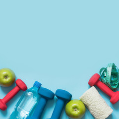 Sport and fitness equipments on blue with copy space.