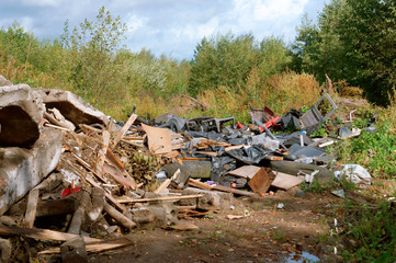 Pollution of the environment by man. Garbage dumping in the forest. Construction and industrial...