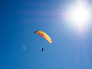 paragliders against the blue sky and mountains