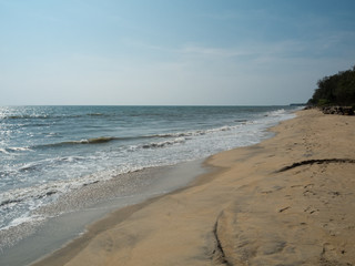 Deserted sandy beach and the waters of the Arabian Sea in the city of Kochi