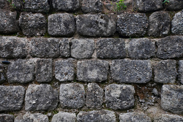 Ancient gloomy wall of gray stones, stonework,