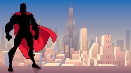 Silhouette of superhero standing tall on city background with copy space. © Malchev