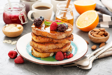 French toasts with fresh berries and honey for breakfast.