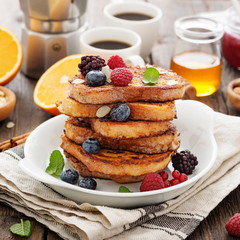 French toasts with fresh berries and honey for breakfast.