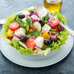 Greek salad with feta cheese, organic black olives, juicy tomatoes, red pepper, red onion, cucumber and lettuce.