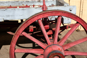 Old red wagon wheel with cobwebs