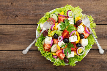 Greek salad with feta cheese, organic black olives, juicy tomatoes, red pepper, red onion, cucumber and lettuce.
