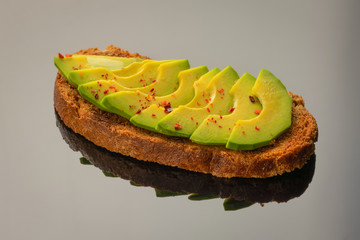 Avocado toast on a gray glass background