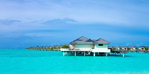 Fototapeta na wymiar tropical beach in Maldives with few palm trees and blue lagoon