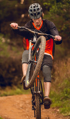 Mountain bike rider going down trail