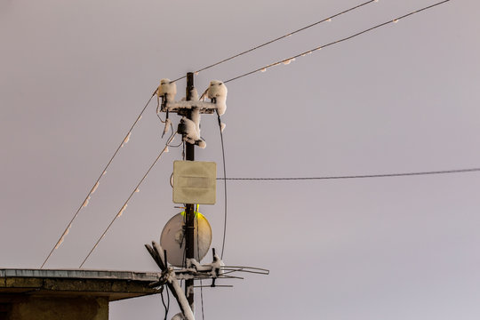 Frozen 5 GHz wireless repeater antennas pillar at winter night