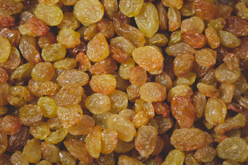 Golden and brown raisins closeup, texture, background