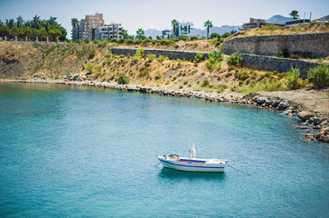 Fototapeta na wymiar Fishing boat stands in the sea near Kyrenia Castle