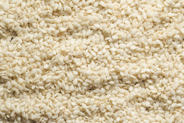White peeled sesame seeds close up, background, texture