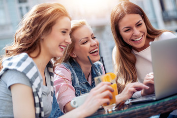 Three friends drinking coffee in a cafe