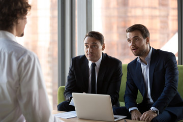 Obraz premium Surprised HR executive managers headhunters or recruitments looking at job vacancy candidature impressed by incredible achievements knowledges. Human resources interview, employment and hiring concept