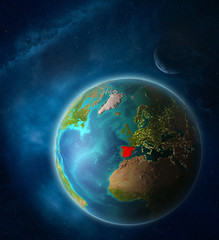 Spain from space on planet Earth in space with Moon and Milky Way. Extremely fine detail of planet surface.