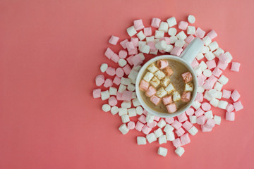 Obraz na płótnie Canvas Cocoa drink with marshmallows isolated onpink or coral background, top view. Christmas hot drink.