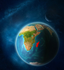 Madagascar from space on planet Earth in space with Moon and Milky Way. Extremely fine detail of planet surface.