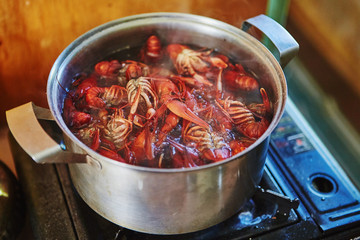 Crawfish cooking boiling in pot with spices