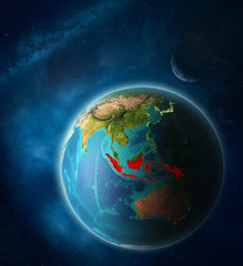 Indonesia from space on planet Earth in space with Moon and Milky Way. Extremely fine detail of planet surface.