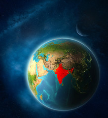 India from space on planet Earth in space with Moon and Milky Way. Extremely fine detail of planet surface.