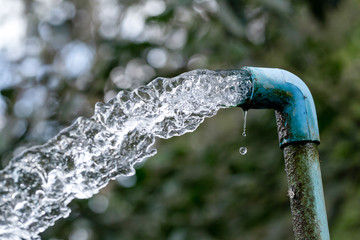 Obraz na płótnie Canvas Blue pipe water flow equipment agriculture.