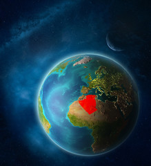 Algeria from space on planet Earth in space with Moon and Milky Way. Extremely fine detail of planet surface.