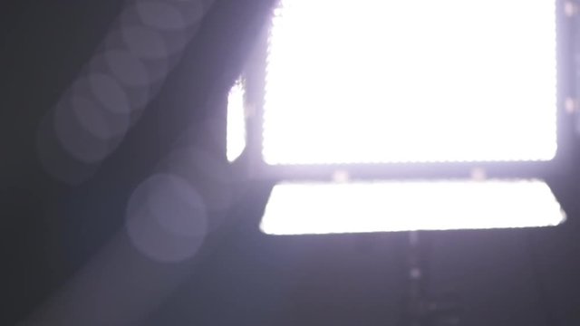 Led light panel in tv studio, close up with selective focus, low key slow motion