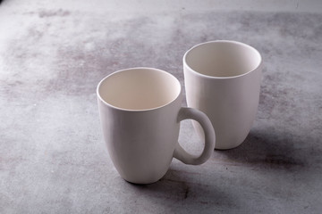 Empty blank white ceramic cup on Cement Board
