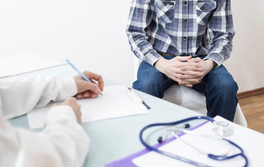A man is sitting at the doctor's office. A doctor urologist advises the patient about prostate cancer. Male diseases.	