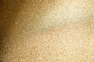 Gold star sparkle party confetti on a gold glitter background