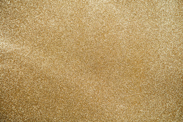 Gold star sparkle party confetti on a gold glitter background