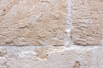 Rough weathered natural old stone wall background, various colored