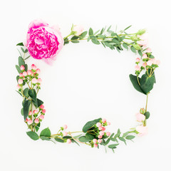 Floral frame of pink peony and roses flowers, hypericum and eucalyptus branches on white background. Flat lay, top view