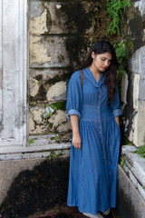 Portrait of beautiful asian woman wearing blue dress walking on street.