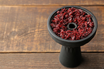 silicone hookah bowl with tobacco with place for text on a brown wooden table. close-up. accessories for hookah. © MK studio