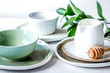 ceramic tableware with flowers on white background